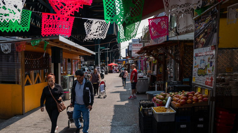 People walking down Roosevelt Ave