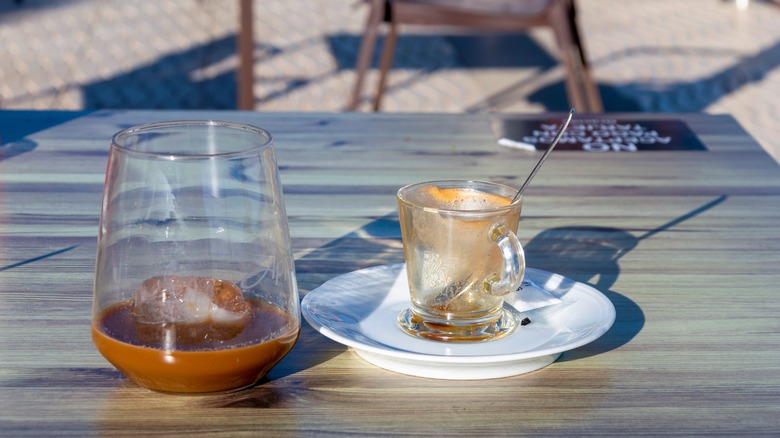 Espresso next to glass of ice