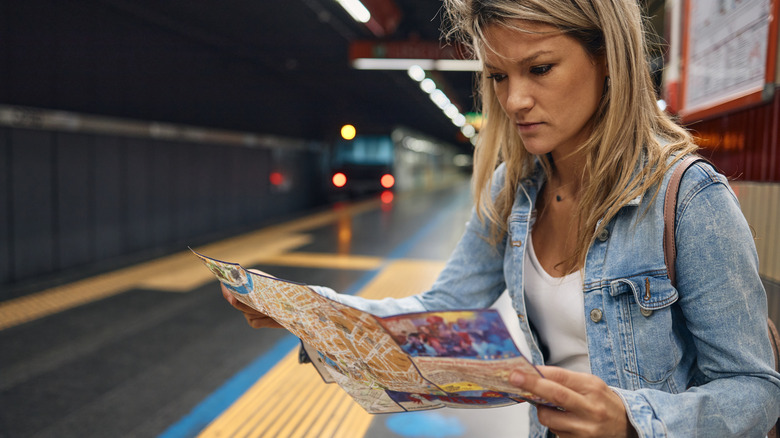 Woman reading station map