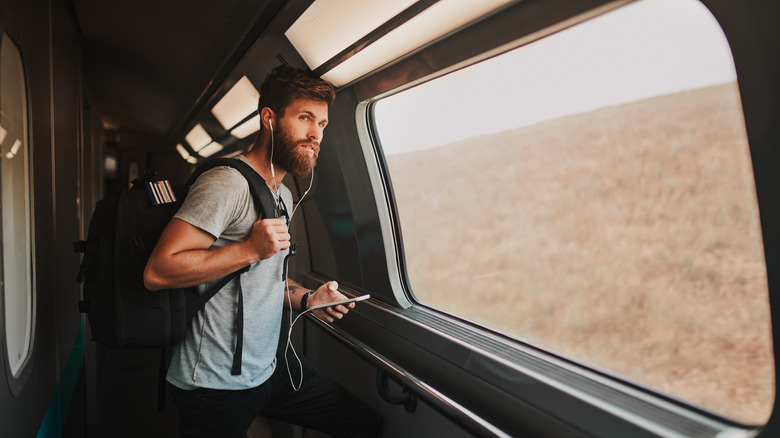 Male train rider with backpack