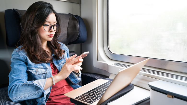 Train passenger using electronics