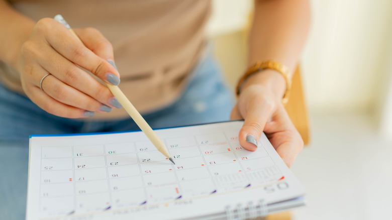 Woman planning trip with calendar