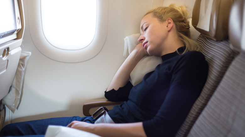 Woman napping on plane