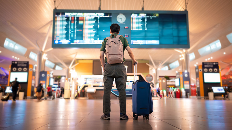 A man standing inside airport