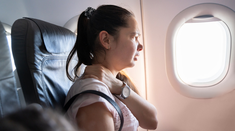 woman uncomfortable on plane