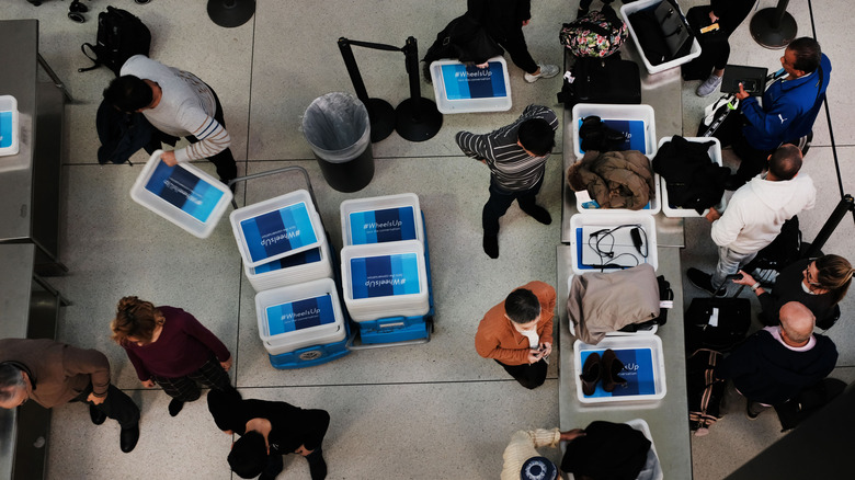 bird's eye view of travelers going through TSA security screeing