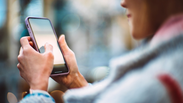 Close-up of woman using smartphone