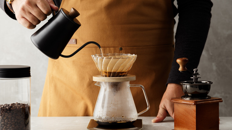 Person making drip coffee pour over