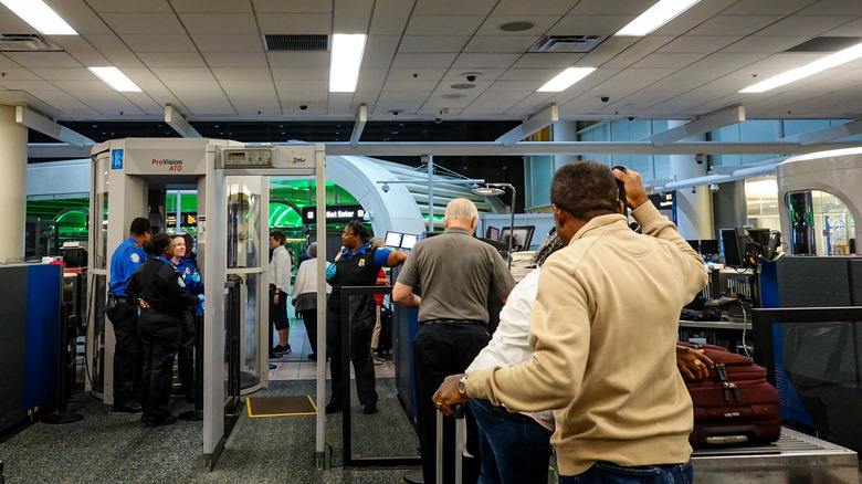 People in airport security checkpoint