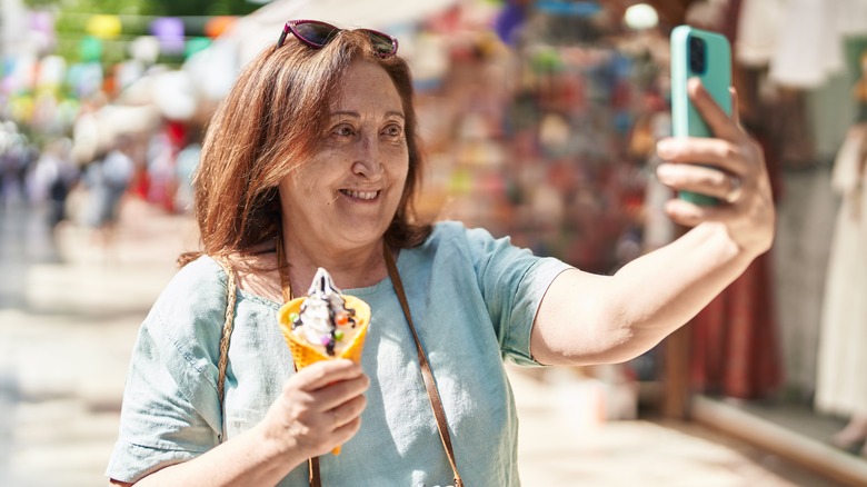 Woman taking selfie with ice cream