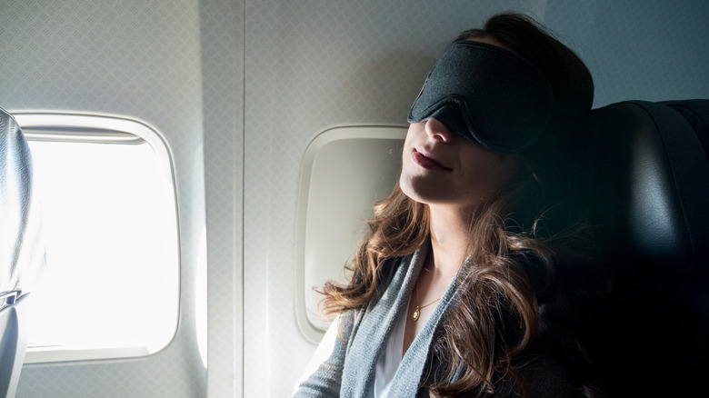 A woman sleeping on a plane 