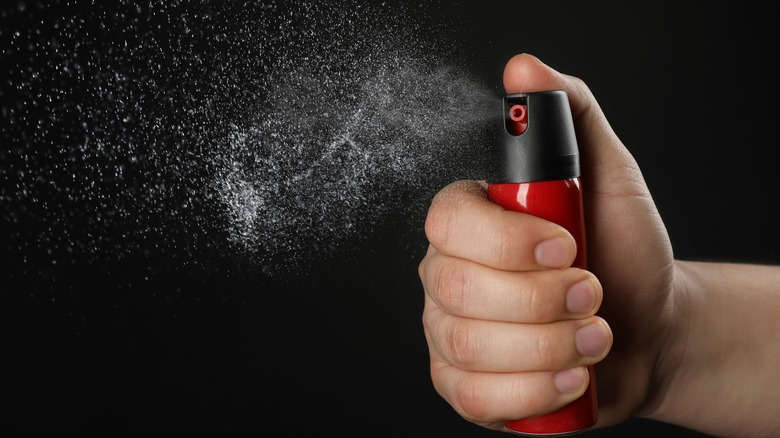 Person activating pepper spray