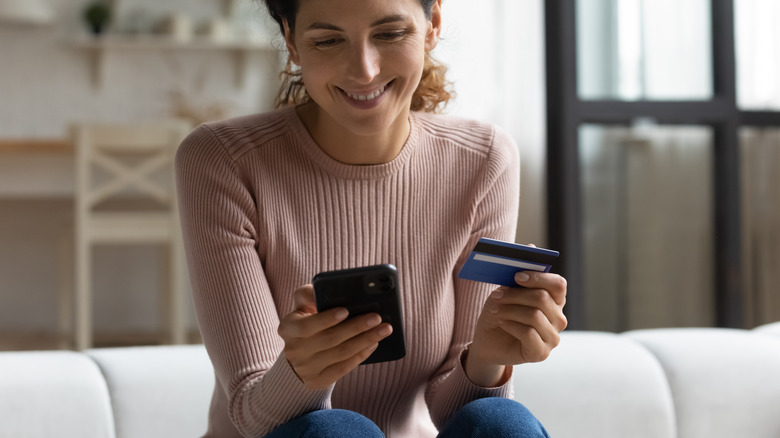 woman with credit card and phone