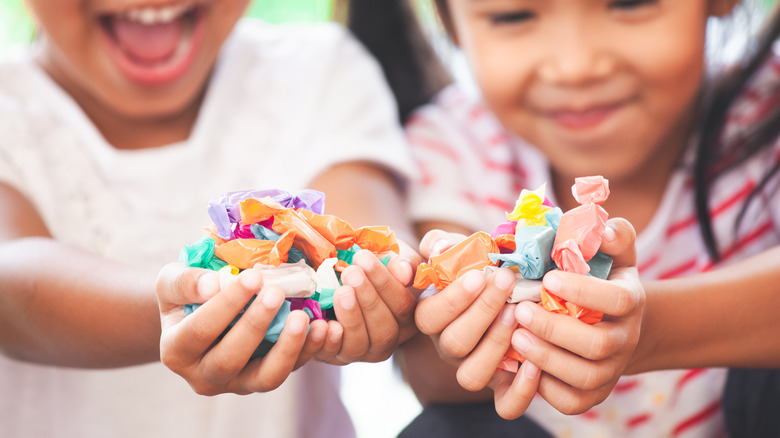 Young girls with handful of candy