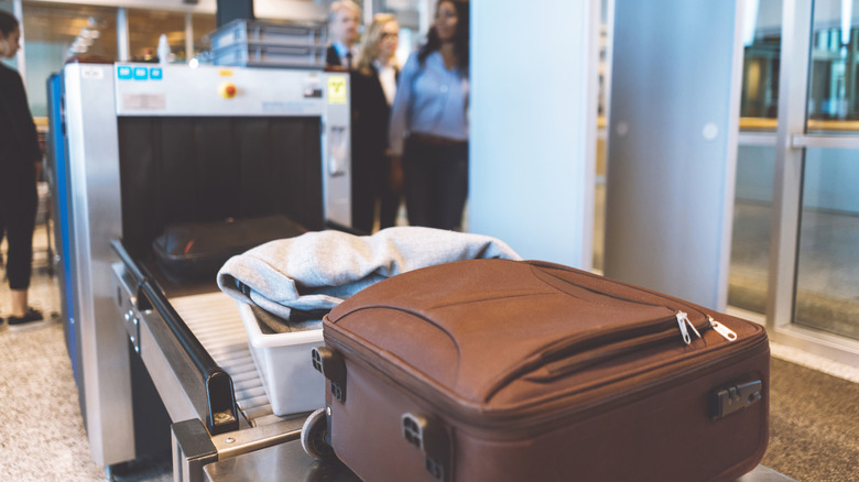 Luggage on TSA conveyer belt after screening.