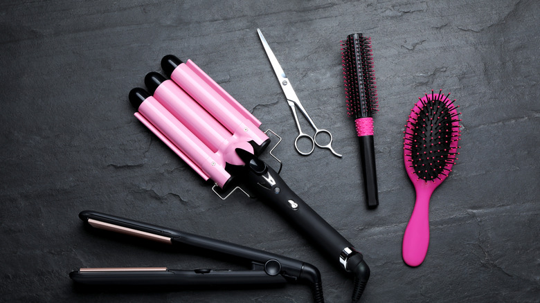 Hair care kit including brush, scissors, curling iron, and straightener.