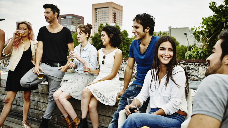 young people lean against wall, Mexico