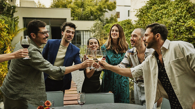 Fashionable people toasting with wine