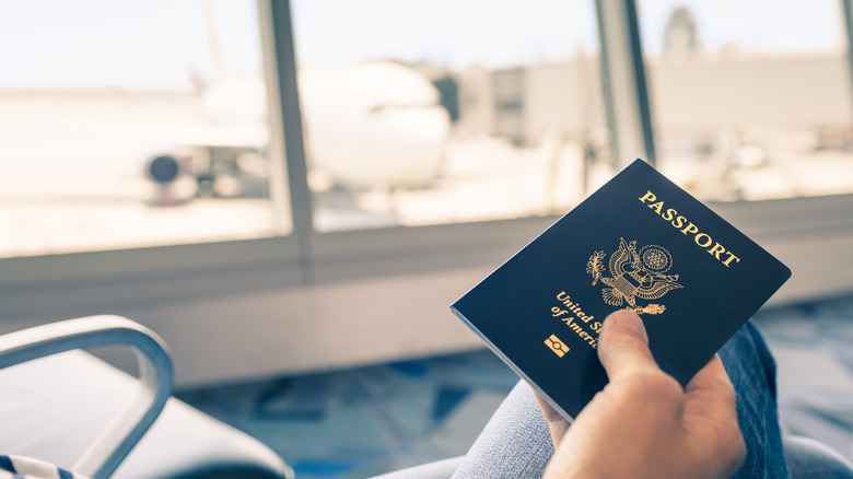 traveler holding American passport in airport