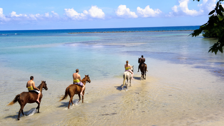 riding horses on the beach in Jamaica