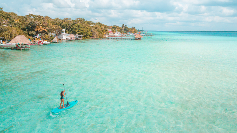 woman paddleboarding on Bacalar Lagoon