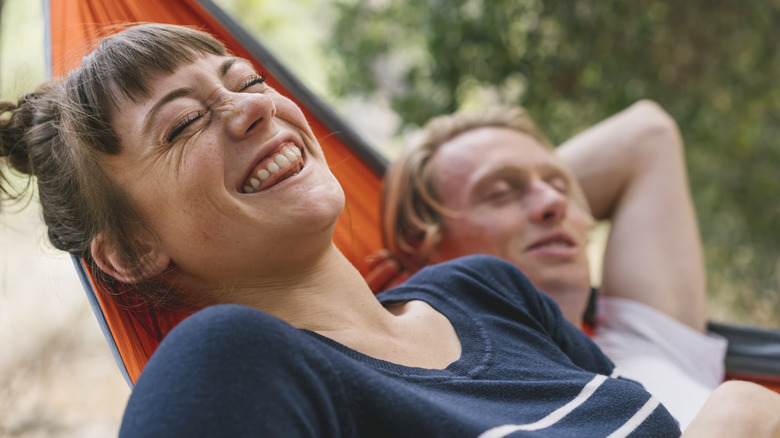 Camping couple relaxing in hammock