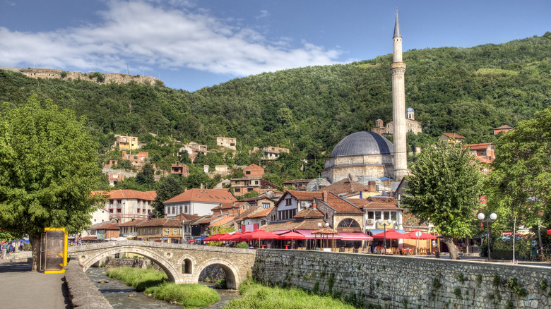 old stone bridge across the river and mosque