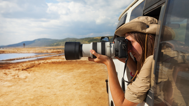 Woman taking photo on safari