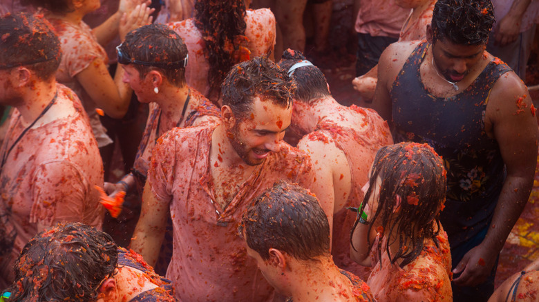 People splattered with tomatoes
