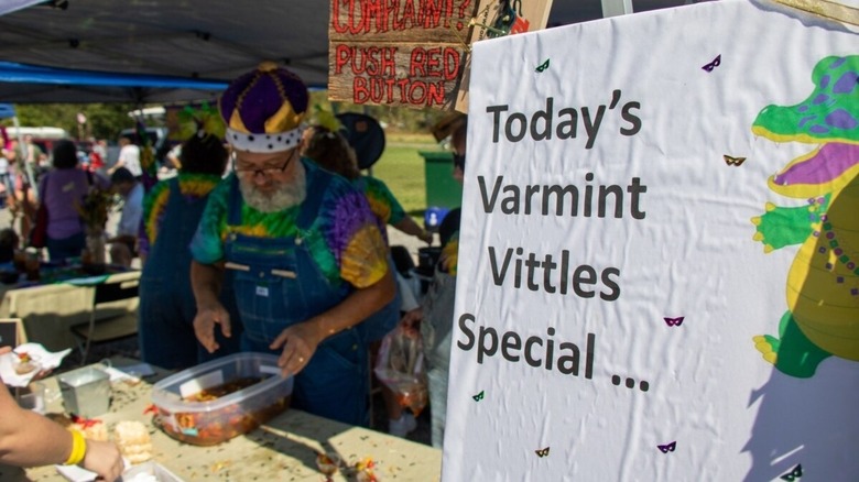 Man cooking varmint in costume