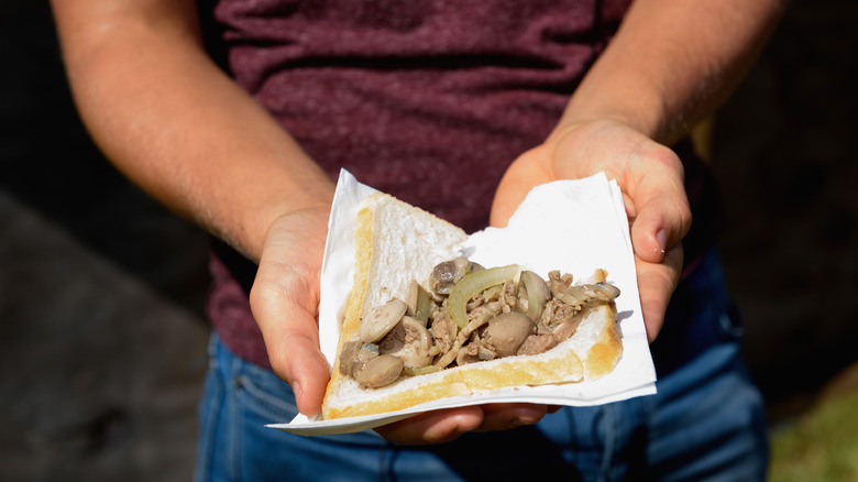 Man holding meat sandwich