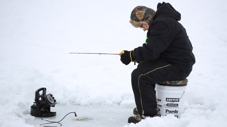 Man sitting and ice fishing