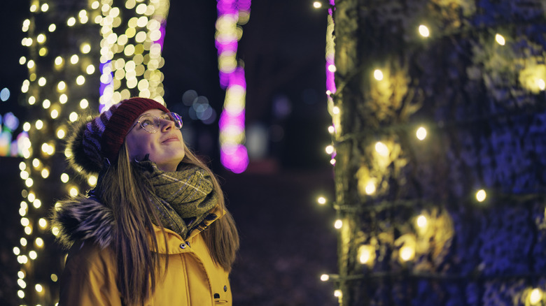 Woman looking up at lights