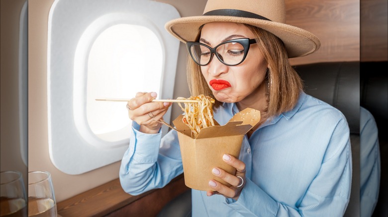 woman smelling foul food