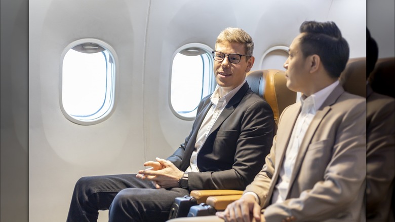 men talking on airplane