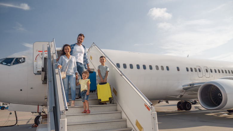 Family exiting airplane