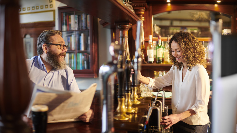 Man at bar in British pub