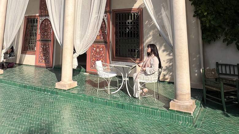 woman sits at cafe in the garden