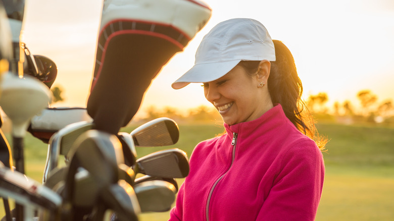 Woman choosing golf club