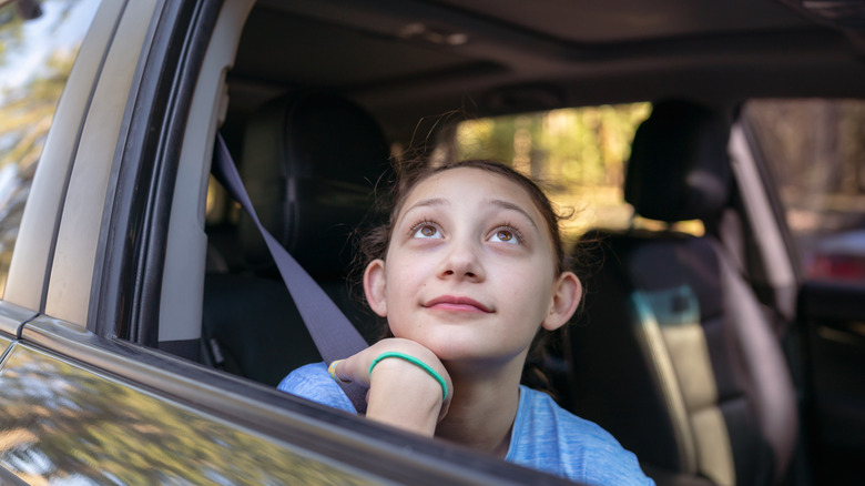 Girl looking out car window