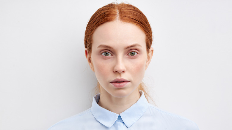 Young woman takes a passport photo