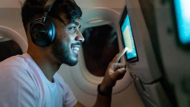 Passenger using in-flight entertainment