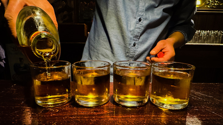 Pouring whiskey into glasses