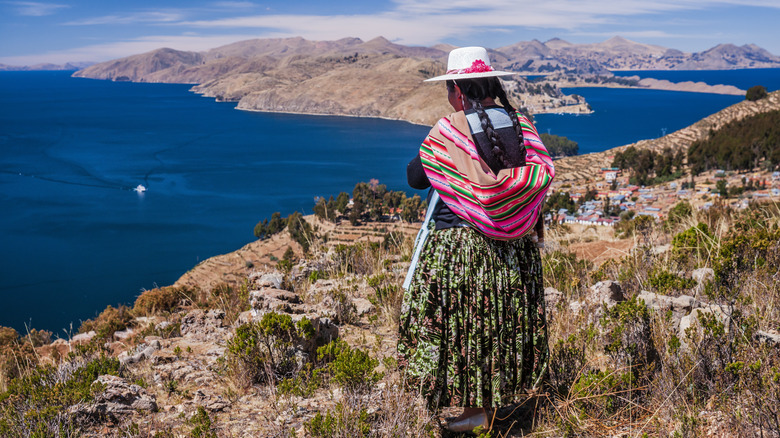 traditionally dressed woman near lake