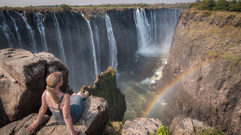 Woman sitting across from Victoria Falls