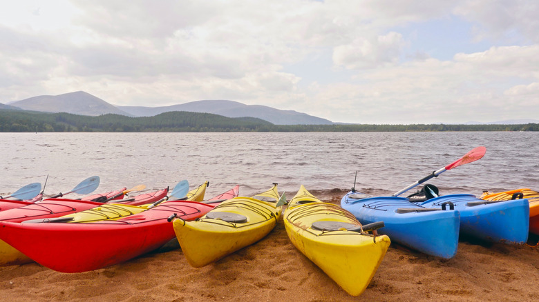 Kayaks on lake mountain under clouds