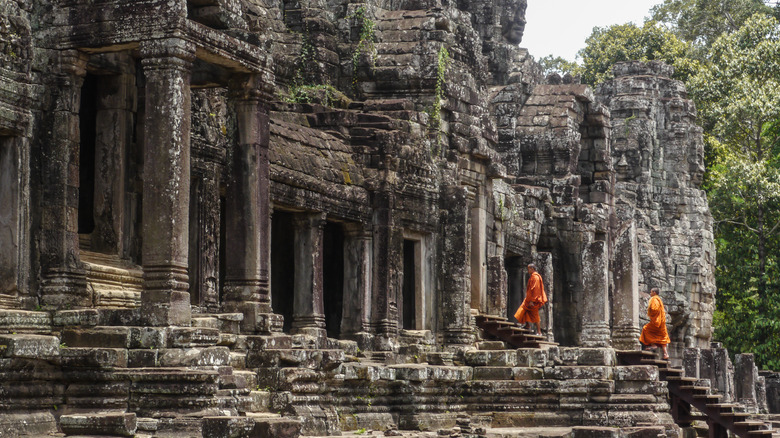 Monks walking through Angkor Wat