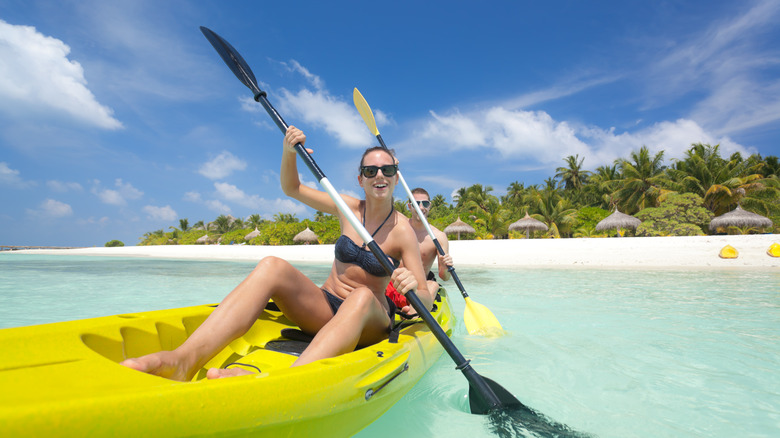 Couple kayaking in tropical water