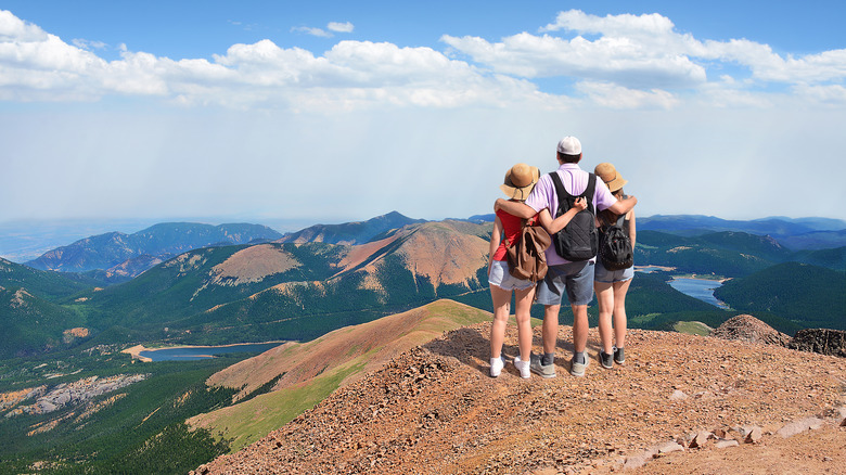 Family standing on mountain summit