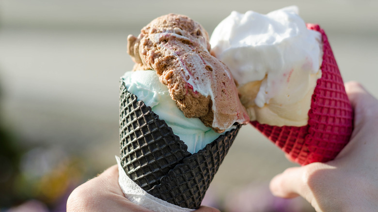 hands holding ice cream cones